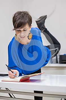 young woman stretching in the office