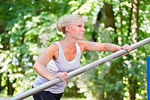 Young woman stretching before sport on fitness trail