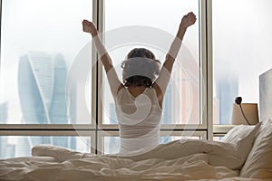 Young woman stretching after waking up photo