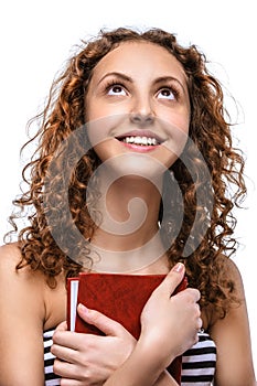 Young woman in striped vest with red book