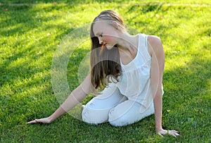 Young woman stroking the grass