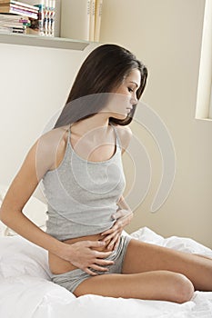 Young woman stroking her belly photo