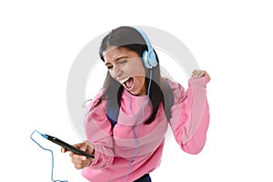 Young woman or student girl with mobile phone listening to music headphones singing and dancing