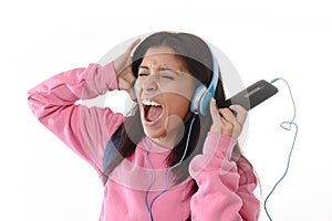 Young woman or student girl with mobile phone listening to music headphones singing and dancing