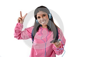 Young woman or student girl with mobile phone listening to music headphones singing and dancing