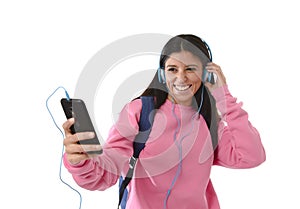 Young woman or student girl with mobile phone listening to music headphones singing and dancing