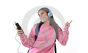 Young woman or student girl with mobile phone listening to music headphones singing and dancing