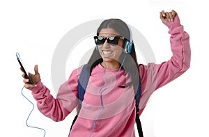 Young woman or student girl with mobile phone listening to music headphones singing and dancing