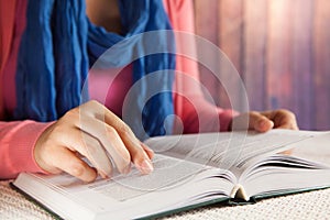 Young woman student read book indoors, leisure or education concept