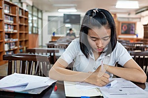 Young woman student reading a book with stress