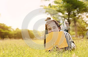 Young woman student reading book in university