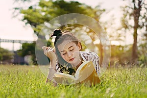 Young woman student reading book in university