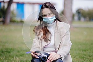 young woman student virtual learning on mobile wearing medical mask new normal