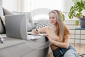 young woman studies online at home