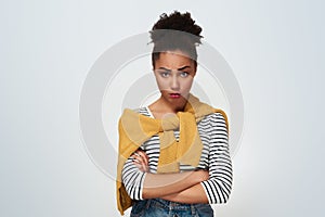 Young woman studio isolated in white crossed arms offended