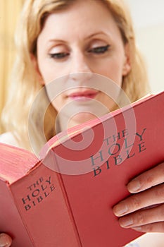 Young Woman Studying Bible At Home