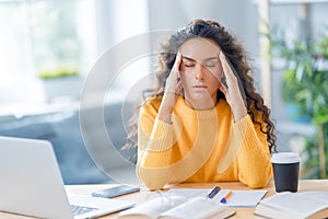 Young woman studying and having a head ache