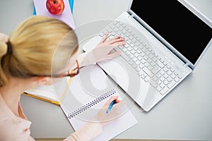 Young woman studying in kitchen