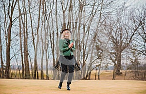 Young woman stylish dressing in eco leather jacket at nature