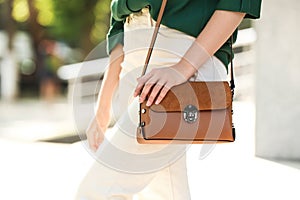 Young woman with stylish leather bag outdoors on day, closeup