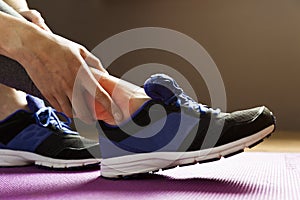 Young woman suffering from an ankle injury while exercising. Sport exercise injuries concept.