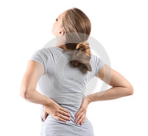 Young woman suffering from back pain on white background