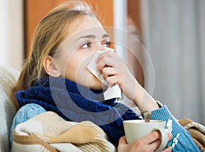 Young woman suffering of cold and having stuffy nose