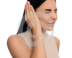 Young woman suffering from ear pain on white background, closeup