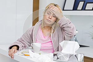 Young woman suffering from headache and cold