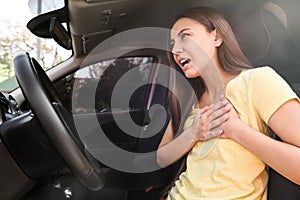 Young woman suffering from heart attack