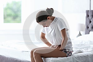 Young woman suffering from menstrual cramps photo