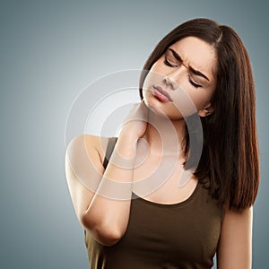 Young woman suffering from neck pain