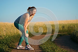 Young woman suffering from pain in her knee