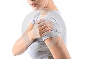 Young woman suffering from pain in shoulder on white background