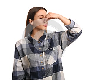 Young woman suffering from runny nose on white background