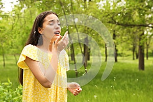 Young woman suffering from seasonal allergy outdoors