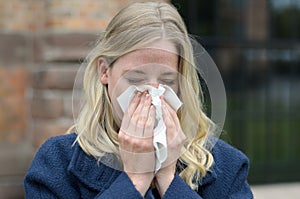 Young woman suffering from a seasonal cold
