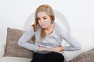 Young woman suffering from stomach ache