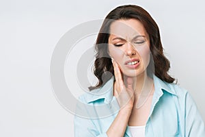 Young Woman Suffering From Strong Teeth Pain, Touching Cheek With Hand. Dentistry Concept