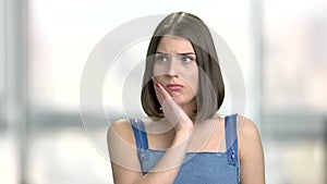 Young woman suffering from toothache.