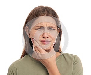 Young woman suffering from toothache on white