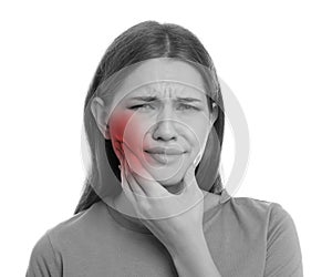 Young woman suffering from toothache on white background. Black and white photo