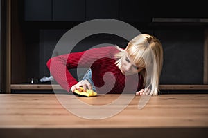 Young woman suffers from depression after a breakup or divorce and from obsessive compulsive disorder OCD cleans kitchen cook top