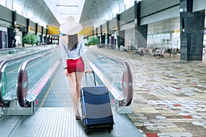 Young woman with a suitcase on the airport