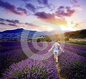 Young woman in summer day in lavender field