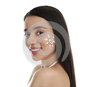 Young woman with sun protection cream on her face against background