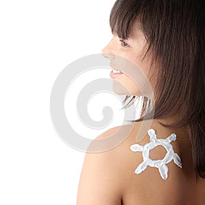 Young woman with sun-shaped sun cream