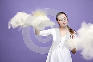 Young woman and sun shining out from behind the clouds, cloud computing or weather concept