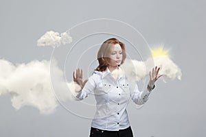Young woman and sun shining out from behind the clouds, cloud computing or weather concept