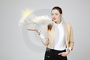 Young woman and sun shining out from behind the clouds, cloud computing or weather concept